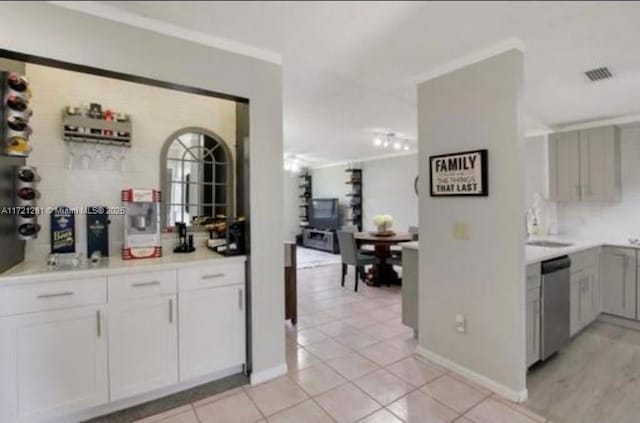 85 Conaskonk Cir Unit 85, Royal Palm Beach, FL 33411 - bar with visible vents, dishwasher, baseboards, a sink, and light tile patterned floors