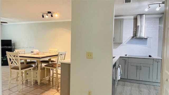 dining room with a textured ceiling and crown molding