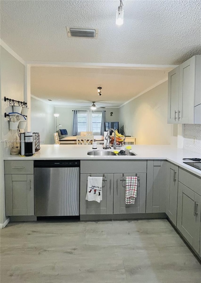 kitchen with gray cabinetry, stainless steel dishwasher, sink, kitchen peninsula, and ceiling fan