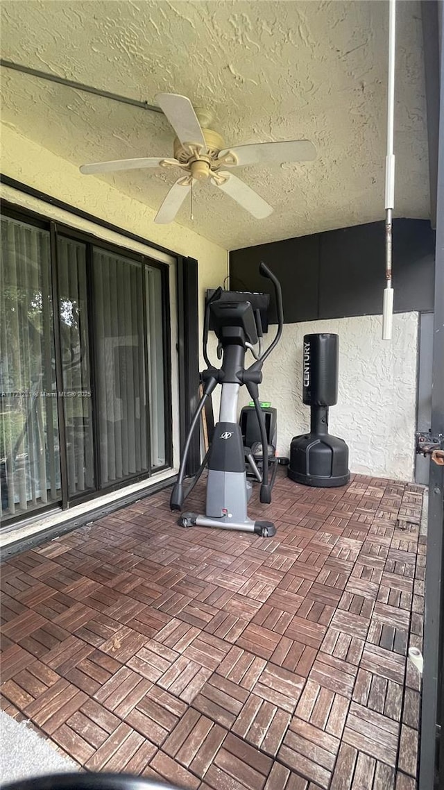 85 Conaskonk Cir Unit 85, Royal Palm Beach, FL 33411 - workout room featuring a textured ceiling and ceiling fan