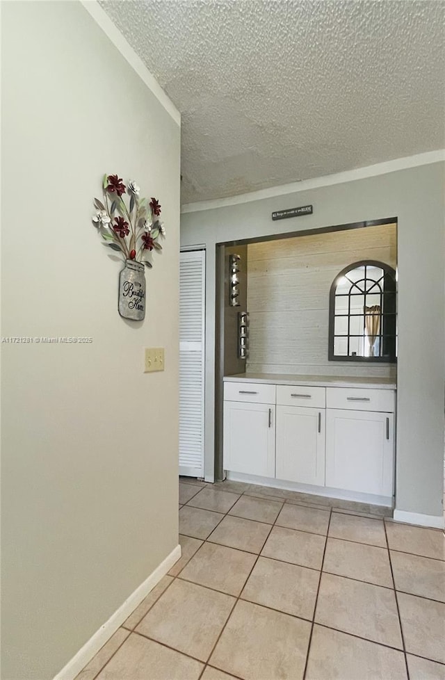 85 Conaskonk Cir Unit 85, Royal Palm Beach, FL 33411 - interior space featuring baseboards, ornamental molding, a textured ceiling, and light tile patterned flooring