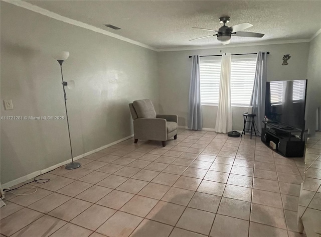 unfurnished room with a textured ceiling, crown molding, and light tile patterned floors