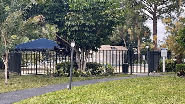 view of gate featuring a yard