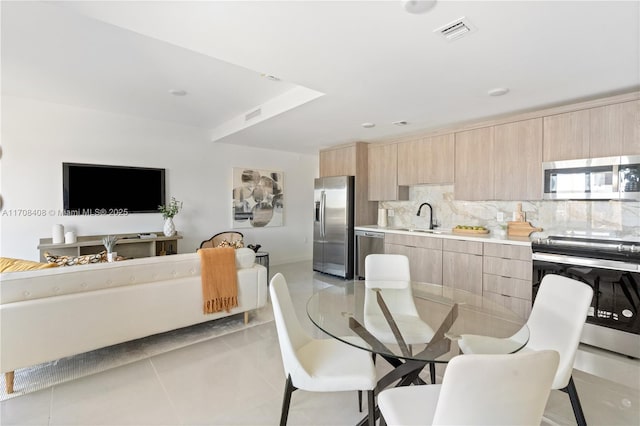 dining room featuring light tile patterned floors and sink