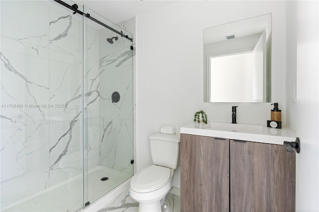 bathroom with vanity, toilet, and a shower with door