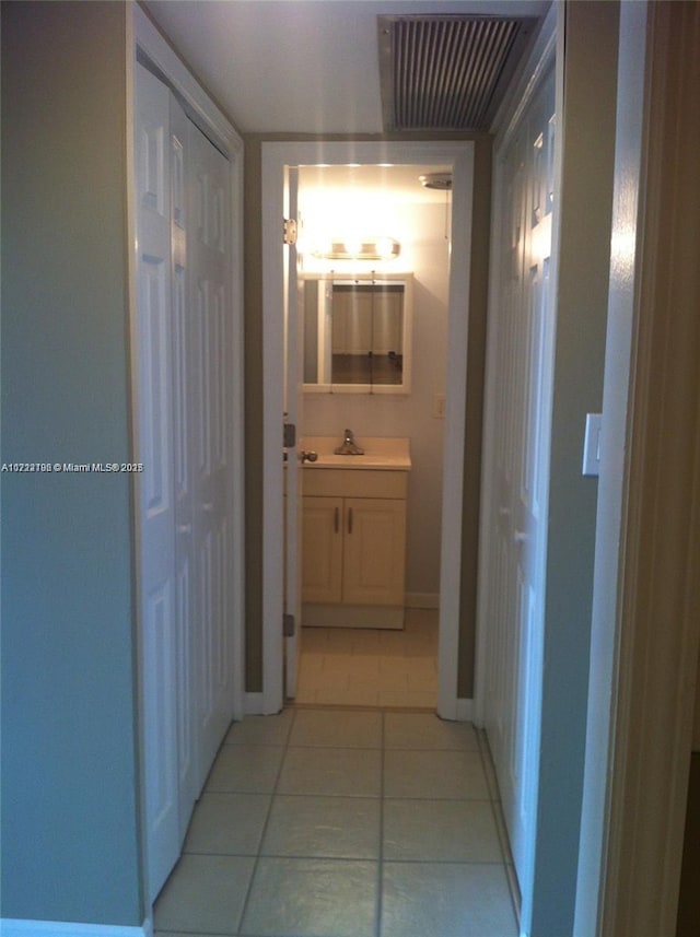 corridor with light tile patterned floors