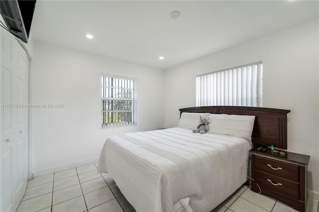 tiled bedroom with a closet