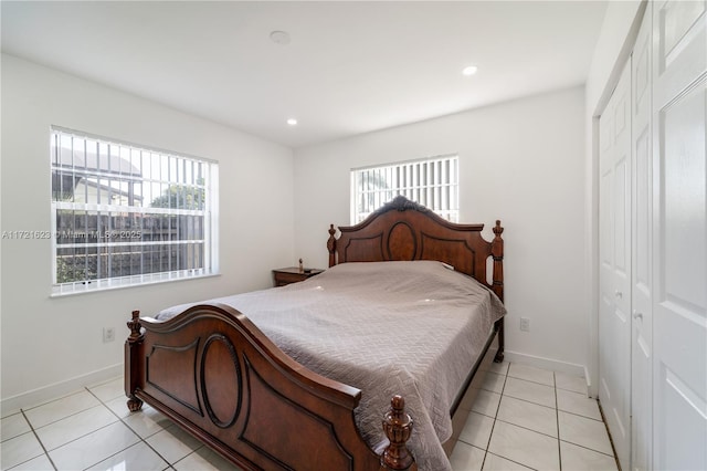 tiled bedroom with a closet