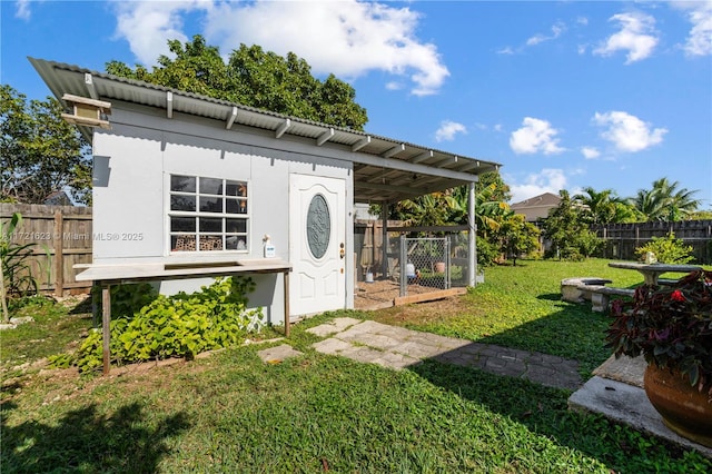 doorway to property featuring a lawn