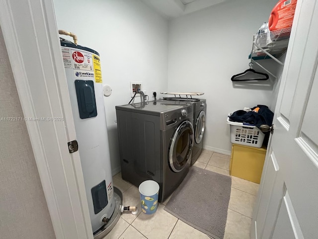 washroom featuring separate washer and dryer, water heater, and light tile patterned floors