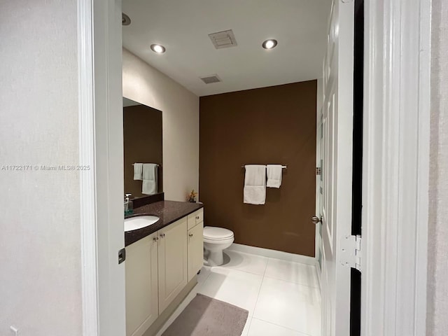 bathroom featuring tile patterned flooring, vanity, and toilet