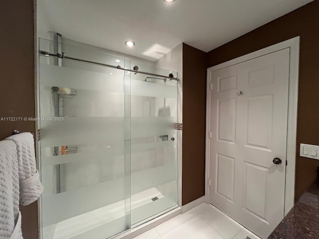 bathroom featuring tile patterned flooring and a shower with shower door