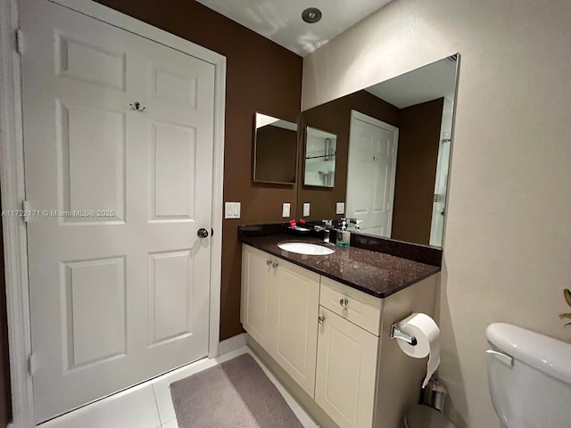 bathroom with tile patterned floors, vanity, and toilet