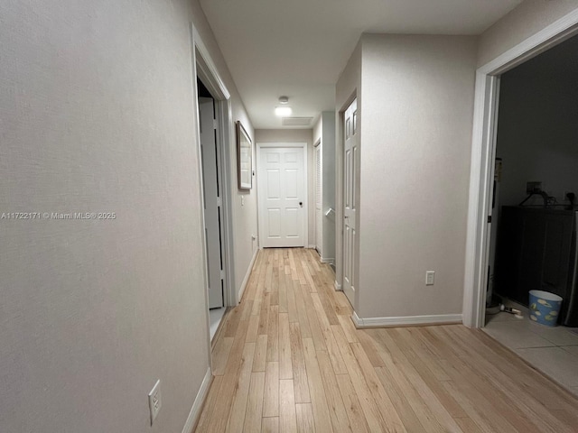 corridor with light hardwood / wood-style flooring