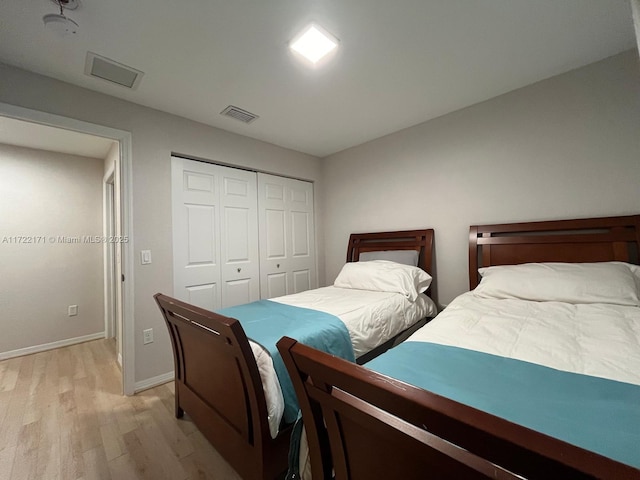 bedroom featuring light wood-type flooring and a closet