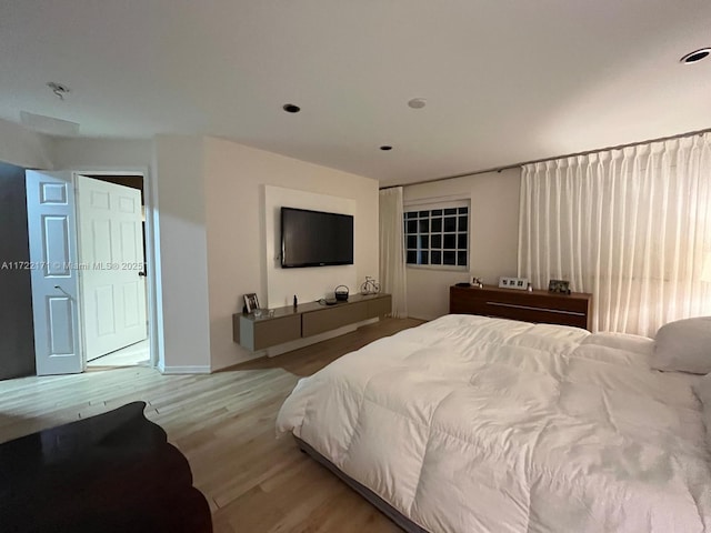 bedroom with light hardwood / wood-style floors