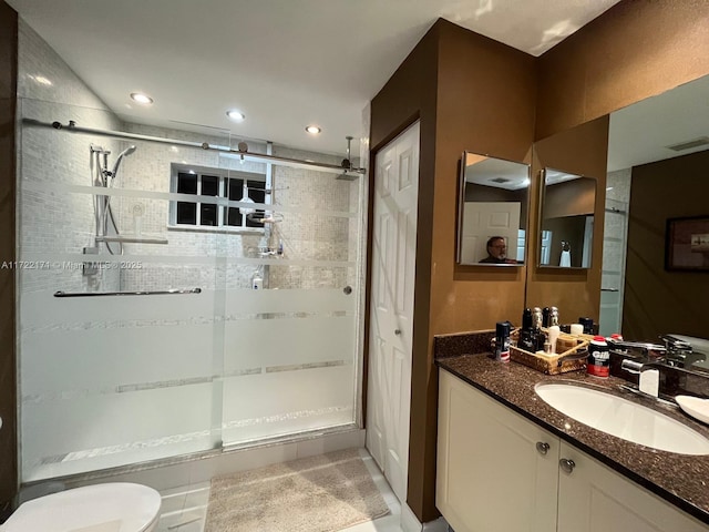 bathroom with tile patterned flooring, vanity, toilet, and an enclosed shower