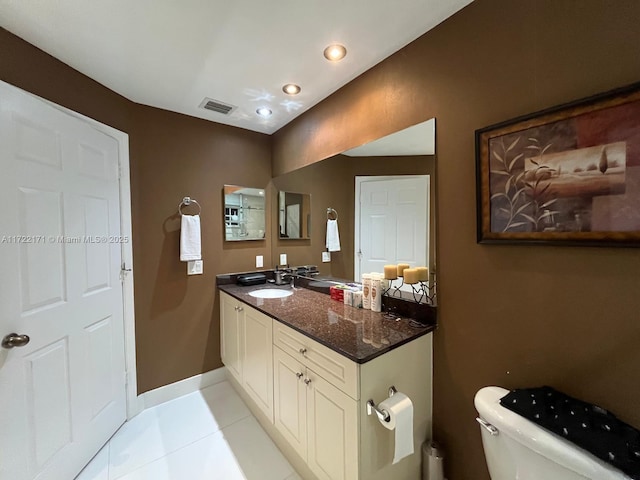 bathroom with tile patterned floors, vanity, and toilet