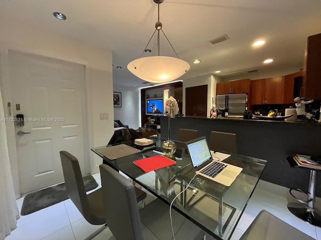 dining space with light tile patterned floors and sink