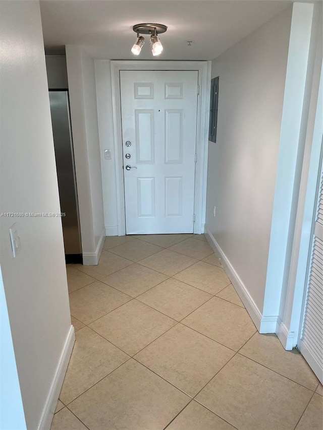 hallway featuring light tile patterned flooring and electric panel