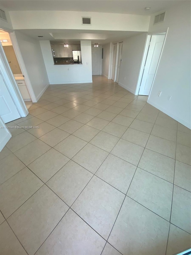 unfurnished living room featuring light tile patterned floors