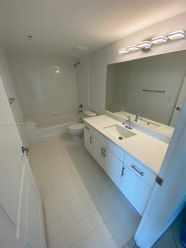 full bathroom with toilet, vanity, tile patterned floors, and tiled shower / bath