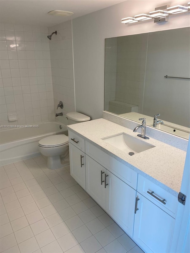 full bathroom with tile patterned flooring, vanity, toilet, and tiled shower / bath combo