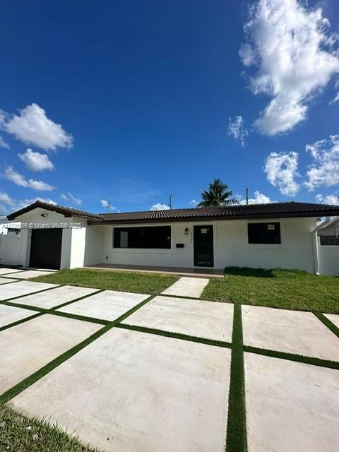 single story home with a patio area and a front yard