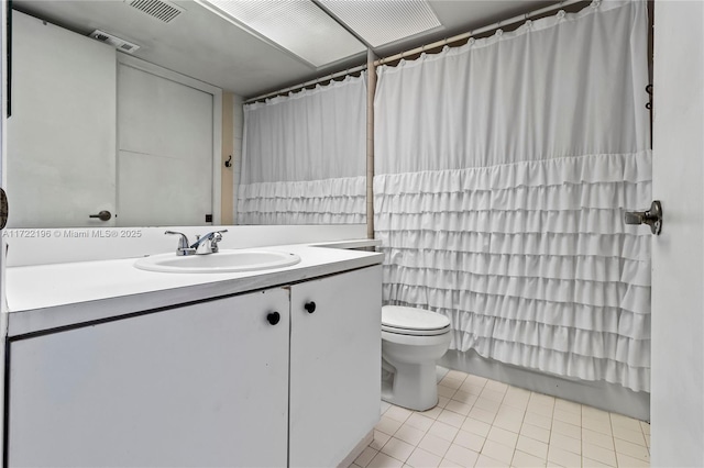 bathroom with toilet, vanity, tile patterned floors, and a shower with shower curtain