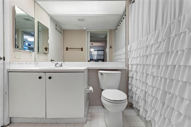 bathroom featuring tile patterned floors, vanity, and toilet