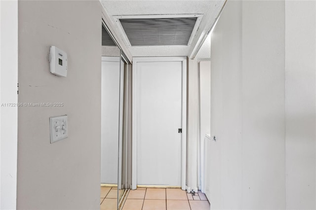 corridor featuring light tile patterned floors