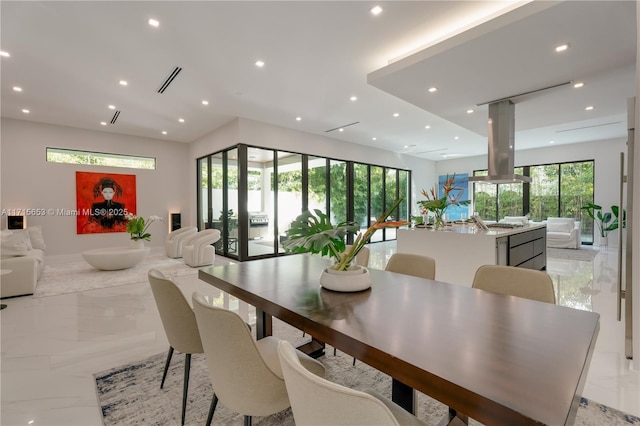 dining space featuring recessed lighting and marble finish floor