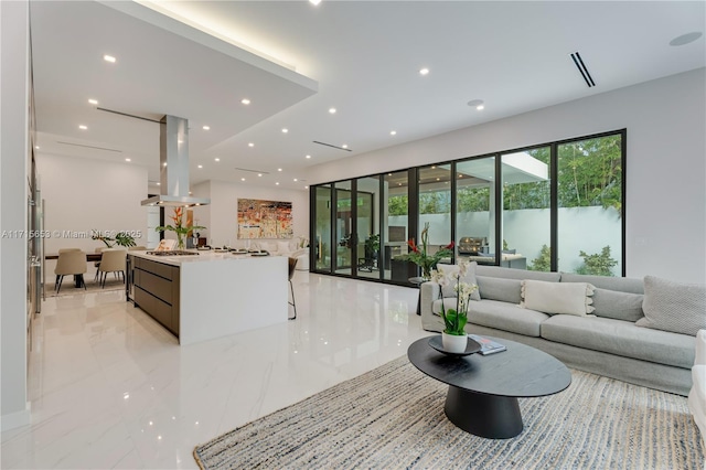 living area featuring marble finish floor and recessed lighting