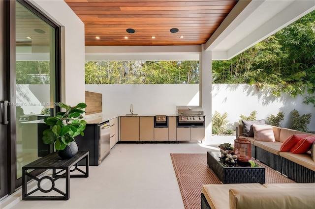 view of patio with an outdoor kitchen, an outdoor hangout area, a sink, a grill, and fence