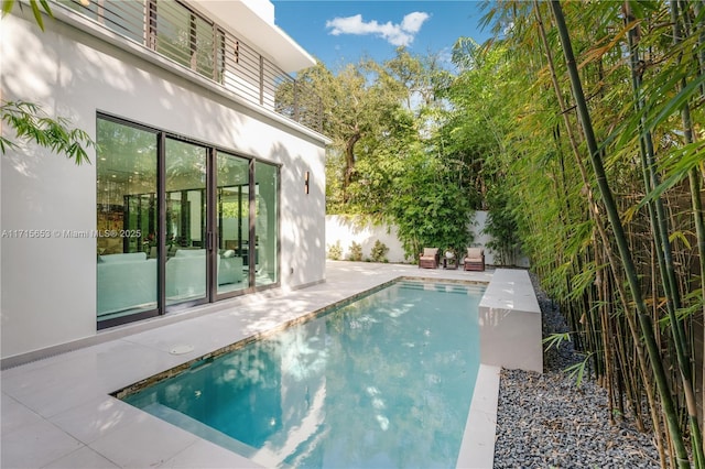 view of pool featuring a fenced in pool, a fenced backyard, and a patio