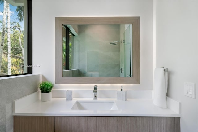 full bath featuring a stall shower and vanity