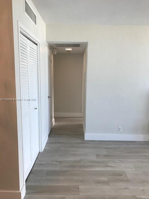 hallway featuring wood-type flooring