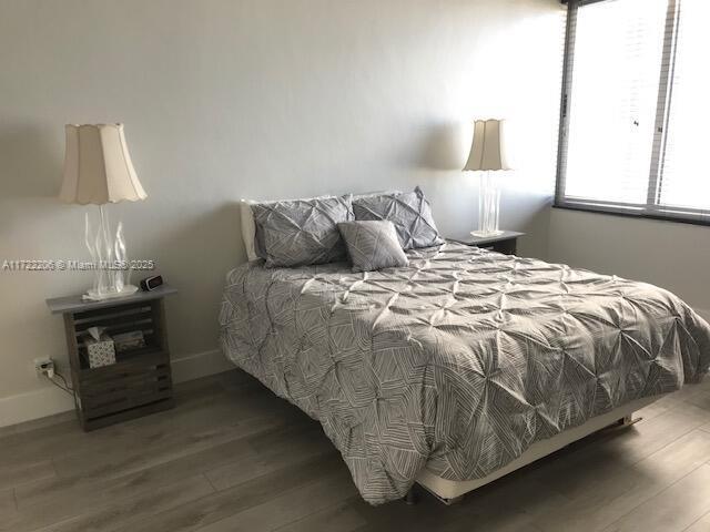 bedroom with wood-type flooring