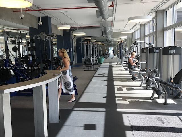 exercise room featuring floor to ceiling windows