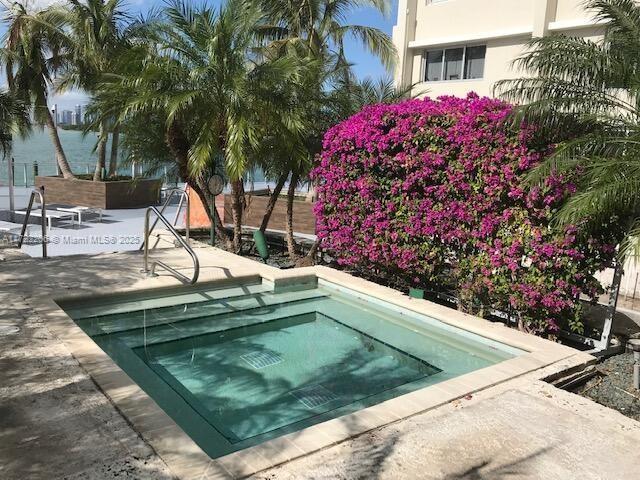 view of pool featuring an in ground hot tub and a patio