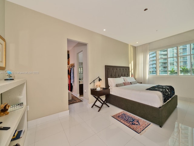 bedroom featuring light tile patterned floors, baseboards, and recessed lighting