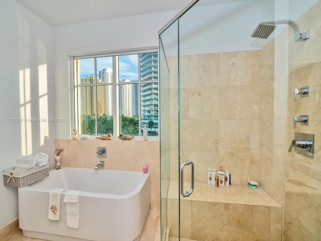 bathroom with shower with separate bathtub