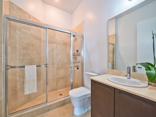 bathroom with tile patterned flooring, vanity, toilet, and a shower with door