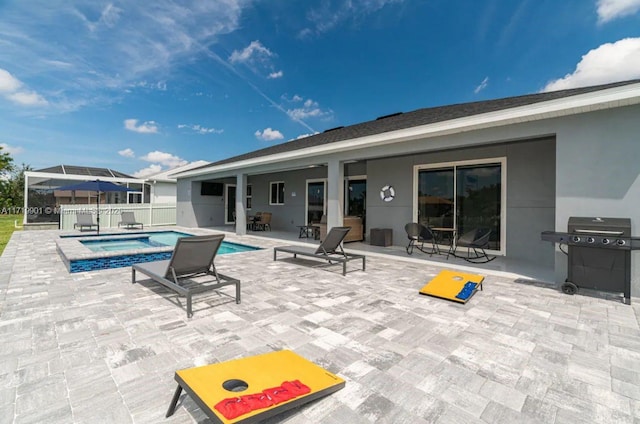 view of pool with an in ground hot tub, a patio, and grilling area