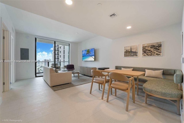 dining space with floor to ceiling windows and electric panel