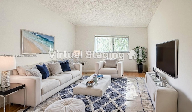 living room featuring a textured ceiling and light wood-type flooring