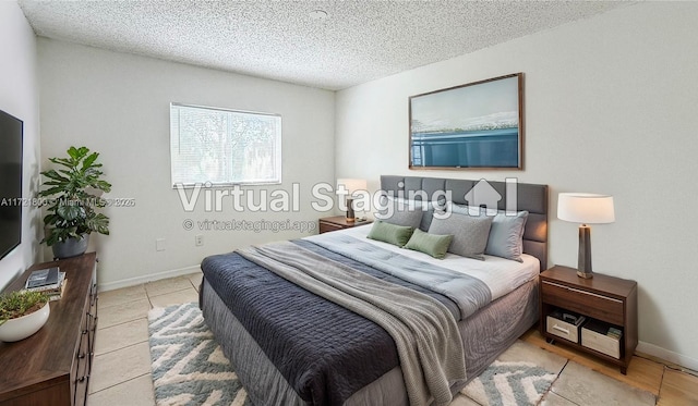 bedroom with light tile patterned flooring and a textured ceiling