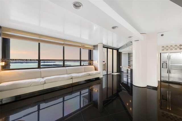 tiled living room with a water view