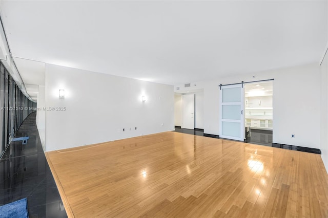 interior space featuring a barn door and dark wood-type flooring