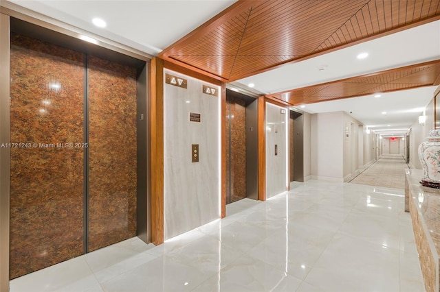 hallway with light tile patterned floors, elevator, and wooden ceiling